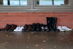 Youth detainees' shoes line the outside of a building at MacLaren Youth Correctional facility in Woodburn, Ore., on Nov. 6, 2025.