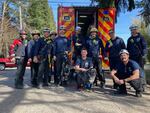 Portland firefighters pose with Tess, the Labrador, shortly after rescuing her from a manhole in Portland, Ore., on March 17, 2023.