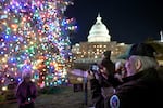 The Christmas tree outside the U.S. Capitol is illuminated as Congress works to finalize a stop-gap spending bill to avoid a government shutdown.