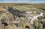 This image released by the University of Oregon shows the Rimrock Draw Rockshelter in Eastern Oregon. UO archeologists have dated a human-made tool to more than 18,000 years old, which would make it oldest human artifact ever excavated in North America.