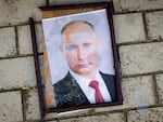A damaged portrait of Russian President Vladimir Putin outside a police station that Kherson residents say was used by Russians as a detention and torture center.