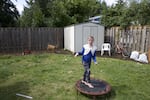 AndaKiss shows off the exercise trampoline in the backyard of the new house.