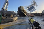 From left: A 7,000-pound anchor, an Ocean Observatories Initiative buoy and an autonomous, data-gathering glider sit on the deck of the R/V Sally Ride after being removed from the Pacific Ocean off Oregon on June 16, 2026.