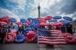 Paris, France: People holding umbrellas reading save democracy take part in the No Kings  protest.