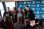 Seattle Soccer legend Megan Rapinoe, center, poses with Seattle Torrent players Alex Carpenter, Hannah Bilka, Cayla Barnes and Hilary Knight at a press conference inside the Space Needle to celebrate their gold medal wins at the Olympics.