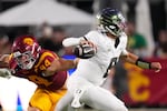 Oregon quarterback Dylan Raiola, right, passes while under pressure from Southern California defensive end Luke Wafle during the second half of an NCAA college football game, Saturday, Sept. 26, 2026, in Los Angeles.