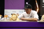 Sam Rollins creating cheese sculpture in one event during Le Mondial du Fromage in Sept., 2023. Rollins’ second place win was the  best an American to date has done in the international cheesemonger competition.