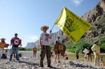 John Rakowitz waves a ‘Don’t tread on Big Bend’ flag at a rally at Big Bend National Park, a pristine pocket of the West Texas border where the federal government is looking to build patrol roads, vehicle barriers and surveillance systems.