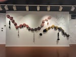 The "Black Excellence Showcase" features two dozen works of art in a variety of media, including large-scale installations like "Intertwined," which uses synthetic hair and pieces of fabric with African prints to comment on Black identity.