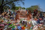 The Robb Elementary School sign is seen covered in flowers and gifts in Uvalde, Texas on June 17.