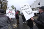 Protesters calling for the reopening of churches and other parts of life curtailed by coronavirus-related emergency orders demonstrate at the Oregon Capitol in Salem, Ore., on May 2, 2020. Two Southern Oregon churches have filed a federal lawsuit alleging the state's limits on religious gatherings amid the coronavirus pandemic violate the U.S. Consitition.