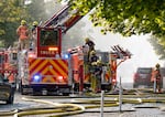 Firefighters and other emergency personnel monitor and battle a fire at a vacant warehouse in Northwest Portland, Ore., on Aug. 2, 2026.