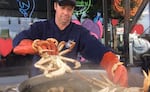 In this 2017 photo, Ryan Rogers drops freshly delivered Dungeness crabs into a kettle at the Fisherman's Market.