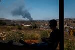 A member of the paramedic team watches a column of smoke rise after an Israeli strike in Nabatiyeh, Lebanon. The fragile ceasefire between Israel and Hezbollah quickly collapsed, with fighting intensifying across southern Lebanon and the Bekaa and casualties continuing to rise. The escalation followed strong Israeli statements calling for increased military action and confirming ongoing operations in the south.