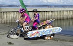 Reed Lacy and Emily Lacy-Nichols pedal their kinetic sculpture.