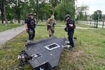 Ukrainian police examine the remnants of a Russian drone that struck in the northeastern city of Kharkiv on Wednesday. Russia began the war with a limited drone arsenal but has dramatically increased production with help from Iran.  