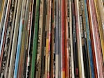 Close-up of a shelf of vinyl LPs, including several album sleeves that read "Curated By Record Store Day"