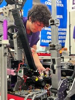 A member of the South Eugene Robotics Team works on a robot nicknamed Marvin.