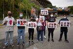 Andreina Baduel (second from right) joins others to protest against the taking of what they call political prisoners outside the Bolivarian National Intelligence Service building known as El Helicoide, in Caracas, Venezuela, Nov 3, 2021. Baduel is the daughter of former Defense Minister Raúl Isaías Baduel, who died in prison in 2021.