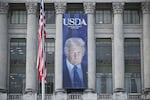 A banner showing an image of President Trump hangs on the side of the U.S. Department of Agriculture building in Washington, DC. The department wants states to turn over records about tens of millions of people who have received federally-funded nutrition assistance by