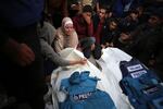 Journalists, relatives and friends pray over the bodies of journalists Sari Mansour and Hassouna Esleem after they were killed in an Israeli bombardment at Bureij camp in the central Gaza Strip on Nov. 19.