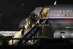 People arrive at the airport after being evacuated from the Middle East on a government flight, in Prague, Czech Republic, Tuesday, March 3, 2026.