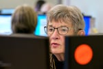 Pat Barcroft of Tigard verifies signatures on ballots at the Washington County Elections Office in Hillsboro, Ore., May 21, 2024. 