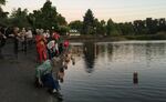 People release paper lanterns into a pond at a 2019 event in Eugene honoring victims of nuclear bombings and radiation.