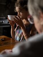 Sara eats breakfast with her grandmother in Italy.