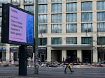 A screen displays the news "Major operation - Chaos in hotel - 16-meter high aquarium in Berlin exploded" in front of the Radisson Blu hotel, where a huge aquarium located in the hotel's lobby burst on Friday.