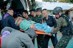 In this photo released by Royal Thai Army, a wounded Thai soldier is carried to be transferred to a hospital in Sisaket province, Thailand, Sunday, Dec. 7, 2025, after, according to a Thai army spokesperson, Cambodian troops fired into Thai territory.