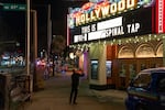 Sean Barry changes the marquee of the century-old Hollywood Theatre as it glows on the evening of Feb. 4, 2026, in Portland, Ore.