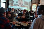 Longtime Trail Blazers fan Robert Cash wears his Blazers hat while getting drinks with colleagues at Spirit of 77 in Portland, Ore., on April 15, 2026. "We'll win this series. I guarantee you," said Cash. "I just feel like everybody is in the right headspace for Portland and then we have a veteran like Damian Lillard back on our team guiding these young brothers [on] how to move and how to win."