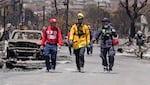 August 12: Members of a search-and-rescue team walk along a street in Lahaina.