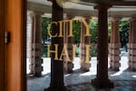 FILE - Pillars mark the entrance to Portland City Hall, reflected in the door, in Portland, Ore., on July 9, 2026.