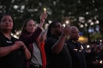 Seattle Mayor Katie Wilson, second left, and Seattle Police Chief Shon Barnes, right, attend the vigil for victims the day after a shooting at Seattle Center during the Bite of Seattle food festival, Monday, July 27, 2026, in Seattle.