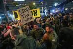 Police scuffle with demonstrators who block a road during a protest demanding a ceasefire deal and the immediate release of hostages held in the Gaza Strip by Hamas, in Tel Aviv, Israel, on Saturday.