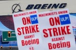 Boeing workers wave picket signs as they strike after union members voted to reject a contract offer, Sept. 15, 2024, near the company's factory in Everett, Wash. The company on Monday made what it called its "best and final" contract offer to striking machinists.