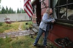 Brenda Palmer, 66, pictured on June 9, 2019, with the sound wall of Interstate 5 seen in the background. Palmer owns one of a dozen properties near I-5 that could see significant construction when a new bridge is built over the Columbia River.