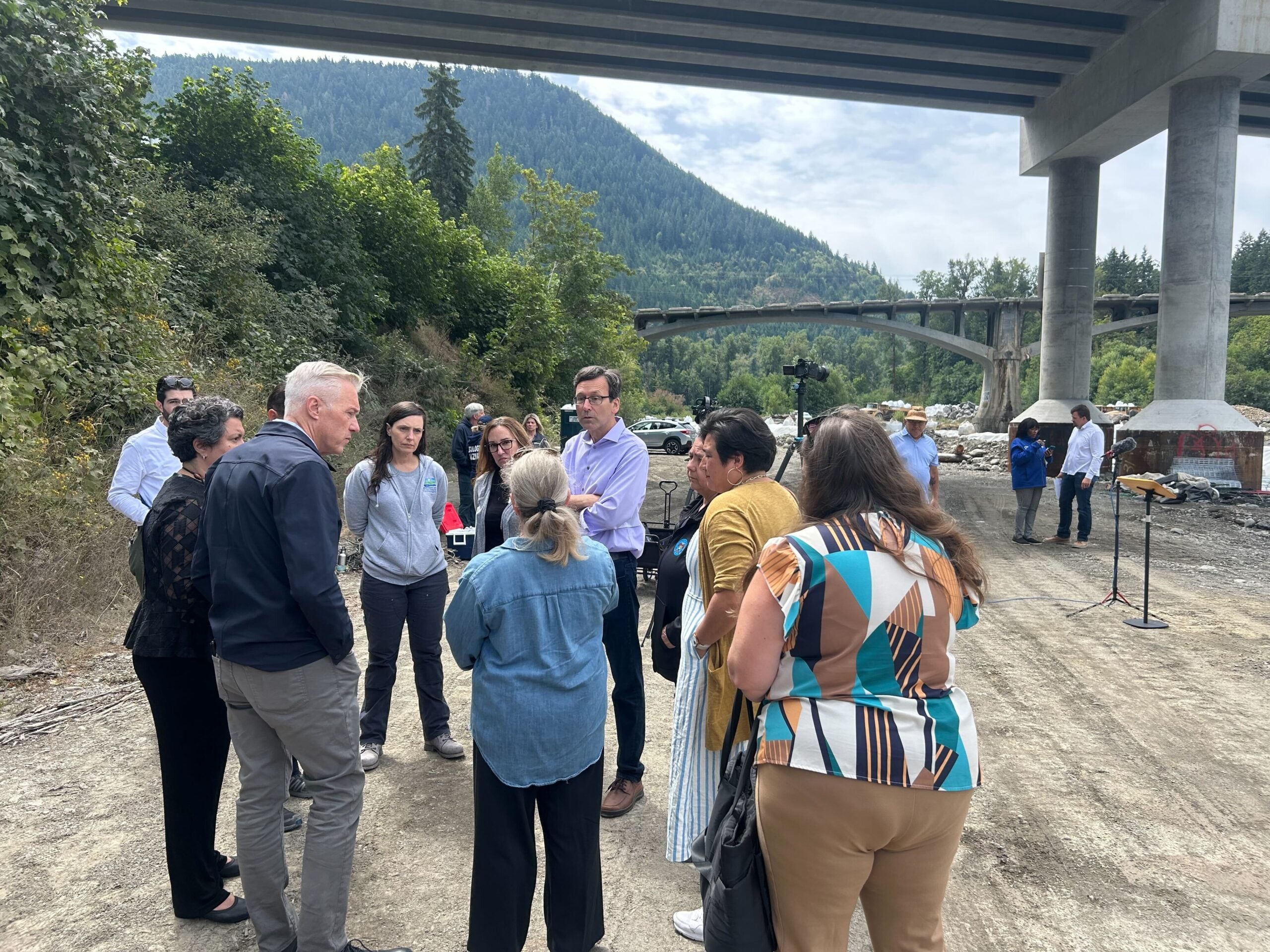 Gov. Bob Ferguson speaks to local, state and federal officials before a press conference along the Elwha River near Port Angeles, Washington, on Sunday, July 20, 2025.