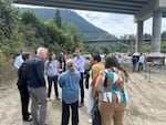 Gov. Bob Ferguson speaks to local, state and federal officials before a press conference along the Elwha River near Port Angeles, Washington, on Sunday, July 20, 2025.