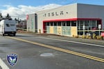 This photo provided by Tigard Police Department shows the boarded-up windows of a Tesla Dealership in Tigard, Ore., Thursday, March 13, 2025, after gunshots were fired for the second time in one week.