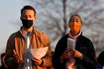 Chris Bettiol, left and Anna Schmeissing prays as they attend an Easter sunrise service held by Park Community Church Sunday, April 4, 2021, at North Avenue Beach in Chicago. (AP Photo/Shafkat Anowar)