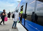Passengers board a MAX Green Line train at the Gateway Transit Center in Portland, Ore. on Aug. 21, 2026. Starting Aug. 23, Gateway will be the final stop for the Green Line, part of a large swath of service reductions.