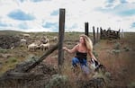 Rancher Jeanne Carver visits some of the sheep on the Imperial Stock Ranch in June 2022. She hired scientists to measure how much carbon is added to the soil on the ranch with changes to grazing patterns and crop production.