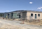 Defective modular homes are seen at the site of Royal Oaks, which burned down in the Almeda Fire, in Phoenix, Ore.