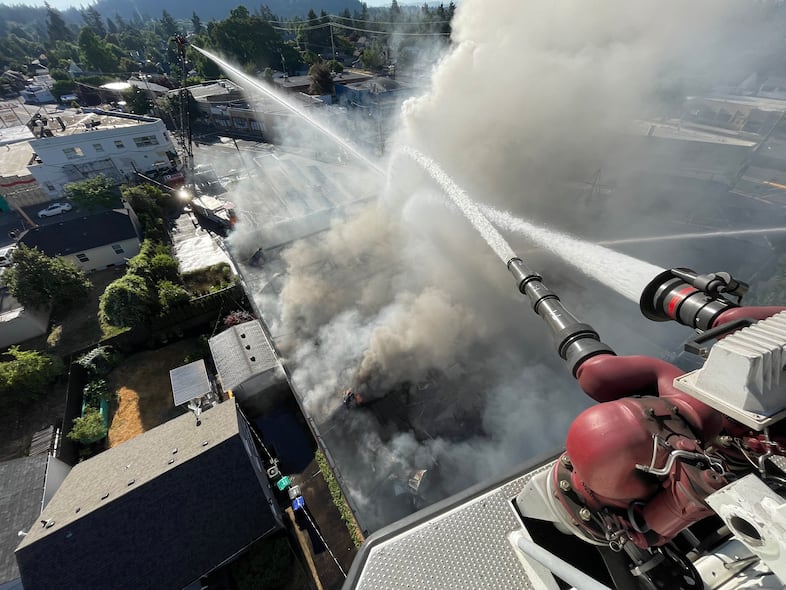 Firefighters from Portland Fire & Rescue battle flames at the historic Roseway Theater which suffered heavy damage from a fire on Aug. 6, 2022.