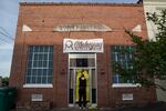Norman Brooks covers the door of the Mahogany Masterpiece dance studio, the scene of Saturday's deadly mass shooting in Dadeville, Alabama.