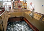 Capt. James Holcroft oversees the hold of the Essayons filling up with dredged sand and seawater.