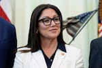 FILE - Labor Secretary Lori Chavez-DeRemer listens as President Donald Trump speaks in the Oval Office of the White House, Oct. 16, 2025, in Washington.